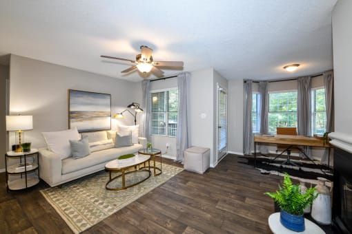 a living room with a ceiling fan and hardwood flooring at 670 Thornton, Lithia Springs, GA