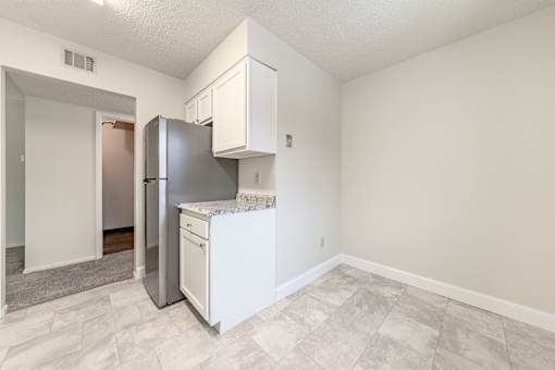 a kitchen with a refrigerator and a sink and a refrigerator