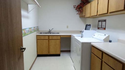 an empty kitchen with a sink and a dishwasher