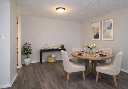 A dining room with a round table and chairs.
