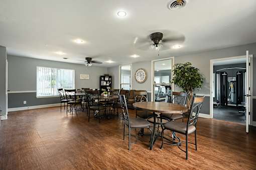 A dining room with a wooden table and chairs.