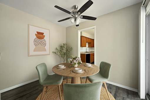 A dining room with a round table and chairs.