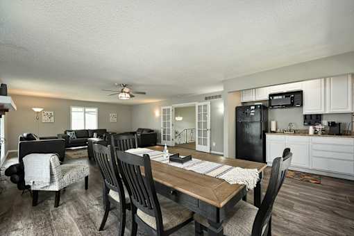 A modern kitchen with a dining table and chairs.