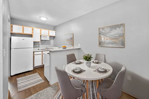 A kitchen with a dining table set for four.