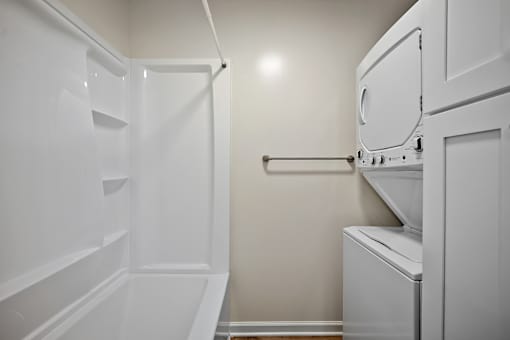A white kitchen with a dishwasher and a refrigerator.