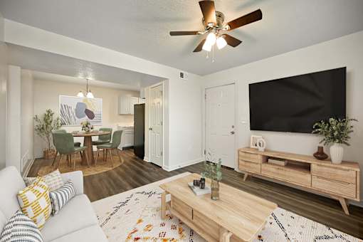 A living room with a white couch and a wooden coffee table.