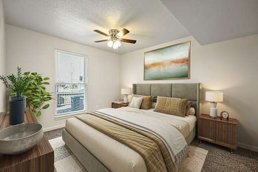 A bedroom with a large bed and a ceiling fan.