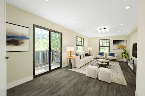 A living room with a white couch and a coffee table.
