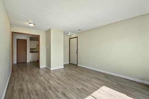 A room with a wooden floor and white walls.