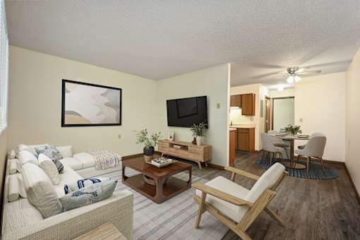 A living room with a couch, chair, and television.