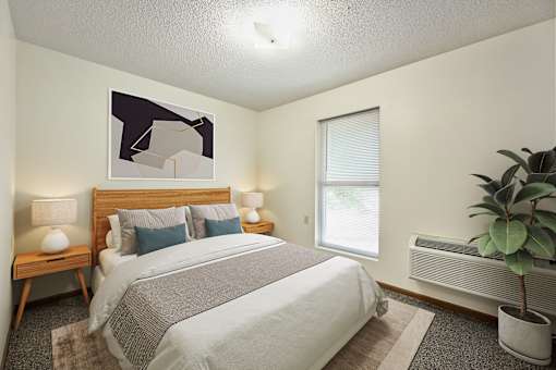 A bedroom with a bed, nightstands, and a plant.