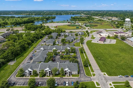 A bird's eye view of a residential area with houses, roads, and a water tower.