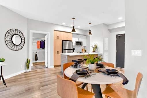 A modern dining room with a round table and chairs.