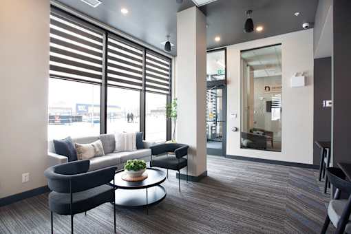A modern waiting room with a view of the street outside.