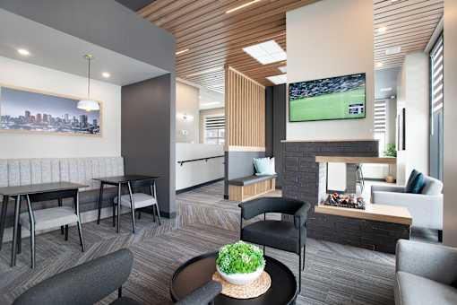 A modern living room with a flat screen TV and comfortable seating.