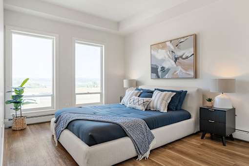 A Bedroom With Two Windows at Podium Apartments, Alberta, T2E 7J2
