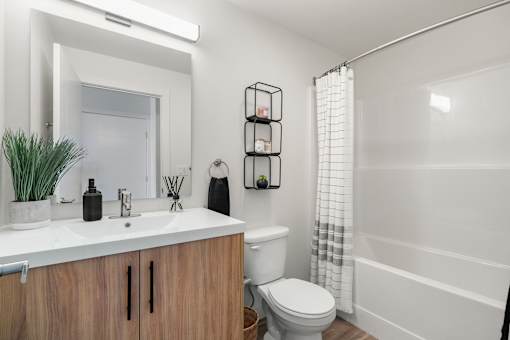 A Bathroom With a White Sink at Podium Apartments, Calgary, Alberta