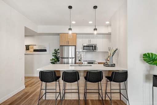 An Open Kitchen With Large Island at Podium Apartments, Alberta
