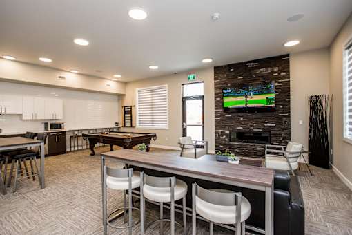 A modern living room with a pool table and a television.