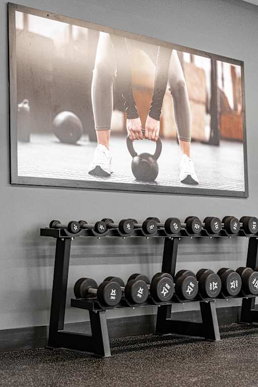 A Gym With Weights at Podium Apartments, Alberta, T2E 7J2
