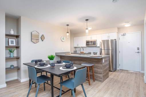 A kitchen with a dining table and chairs. at G17 Apartments at Tamarack, Edmonton, T6T 2M4