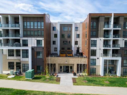 Apartment complex with a mix of brown and white buildings.