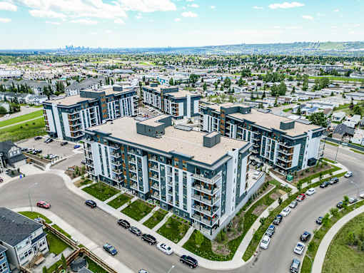 A large, modern building with a parking lot in front of it.