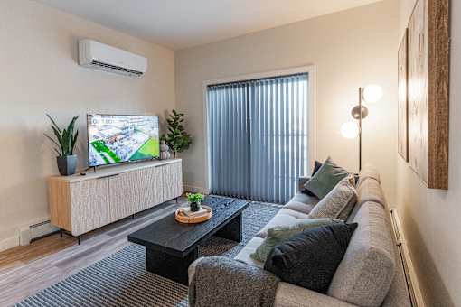 A Living Room With a Flat Screen TV at Cadence at Griesbach, Alberta