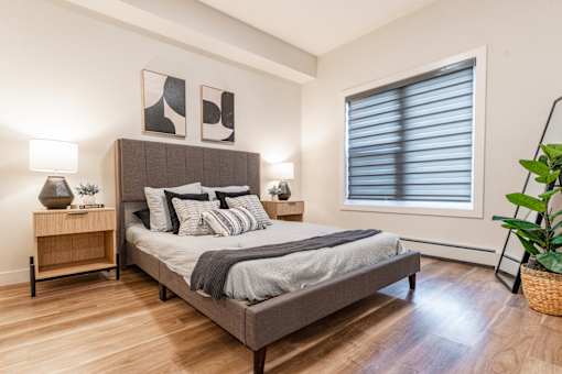 A Bedroom With Two Lamps at Cadence at Griesbach, Alberta, T5E 1Y8