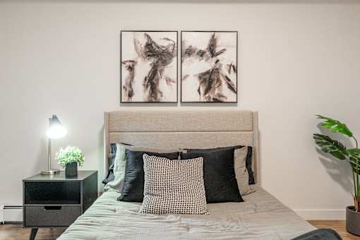 A Bedroom With a Nightstand at Cadence at Griesbach, Alberta