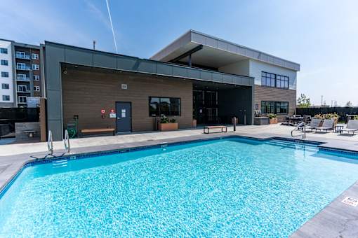 A large swimming pool in front of a modern building.