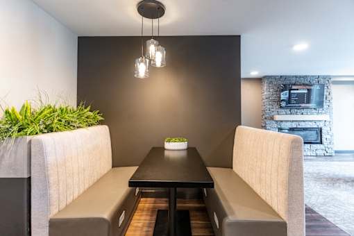 A modern dining area with a table set for two.
