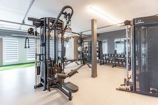 A gym with a variety of equipment including a leg press machine.