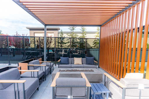 A patio with orange and grey furniture.