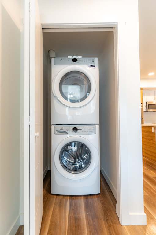 A white washing machine and dryer in a small laundry room.