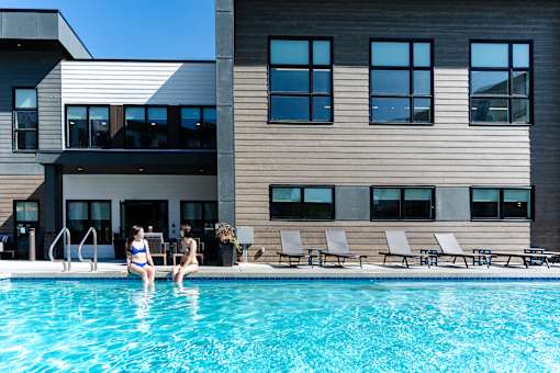 A Swimming Pool With Lounge Area at Podium Apartments, Alberta