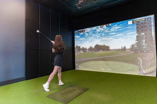 A Woman Is Playing Golf at Podium Apartments, Calgary, AB, T2E 7J2