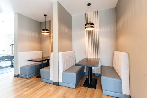 A modern dining area with a long table and chairs.