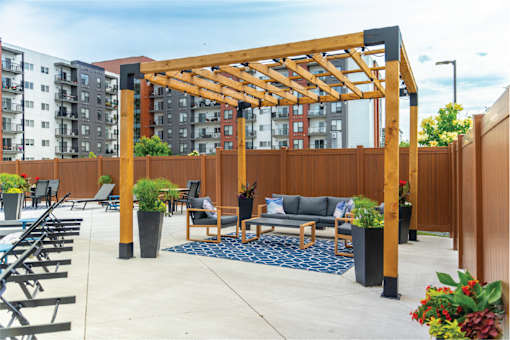 A wooden pergola is over a seating area.at Latitude 49 Townhomes, Manitoba