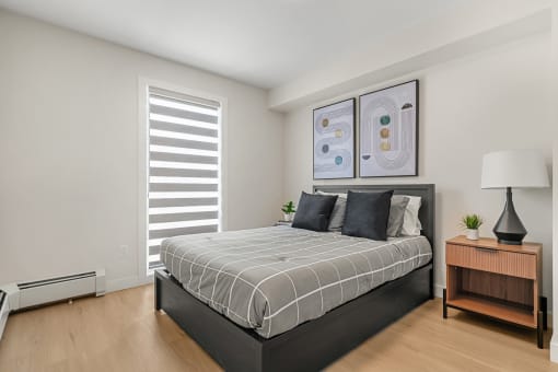 a bedroom with a bed and a window