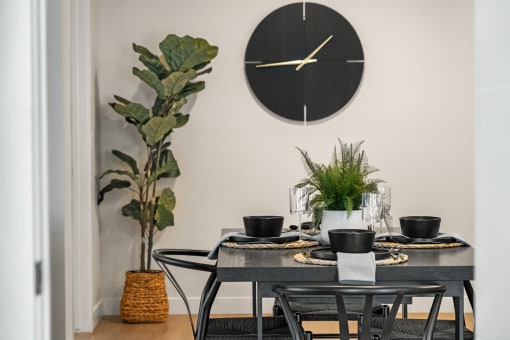 a dining room with a table and a clock on the wall