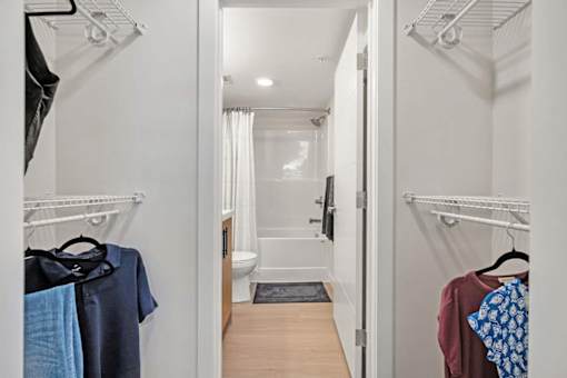 A white bathroom with a toilet, sink, and shower.