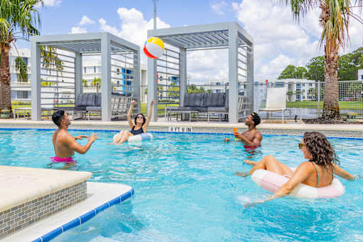 People playing in a pool with a ball.at Icon One, Daytona Beach, Florida