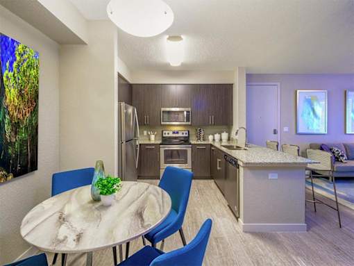 a kitchen and dining room with a table and chairs at Icon One, Florida, 32114