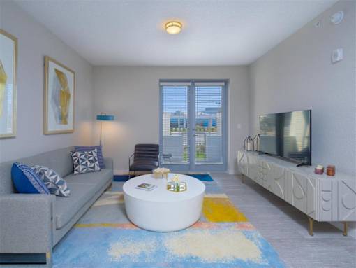 a living room with a couch and a coffee table and a tv at Icon One, Florida, 32114
