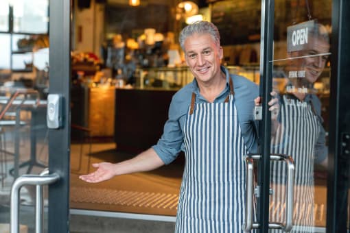 Shop owner standing in the door to his store