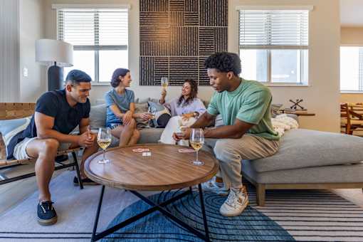 Four people sitting on a couch and a table in front of them.at Icon One, Daytona Beach, Florida