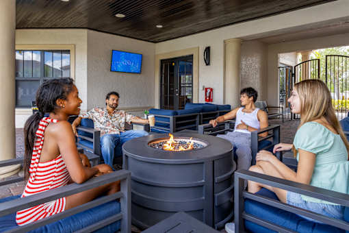 Group of people sitting around firepit at Portofino Cove, Fort Myers, 33916