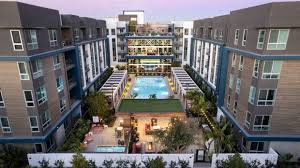 an aerial view of an apartment complex with a swimming pool