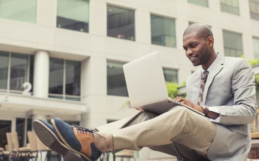a man sitting in front of a laptop computer